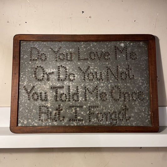 Decorative sign with text on a white wall