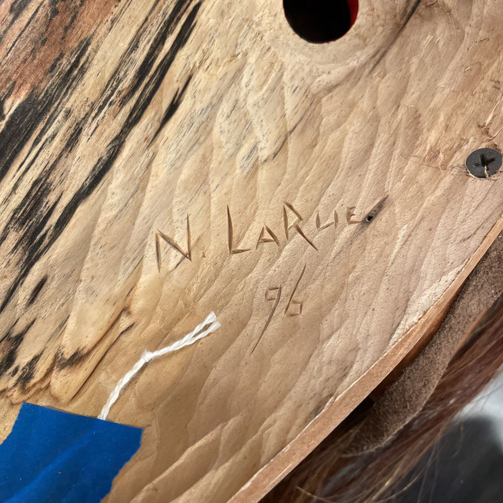 Wooden surface with engraved signature and number