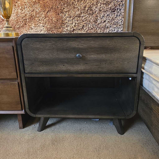 Wooden nightstand with a single drawer in a room setting
