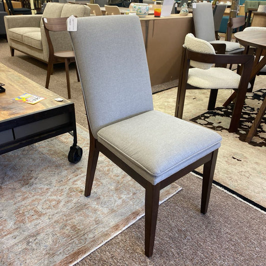 Chair with a gray cushion in a furniture store setting