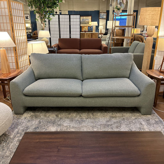 Gray sofa in a room with other furniture and decor