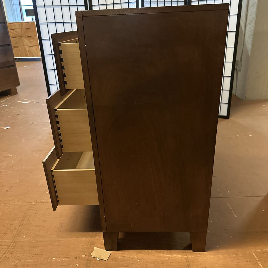 Wooden cabinet with open drawer on a tiled floor