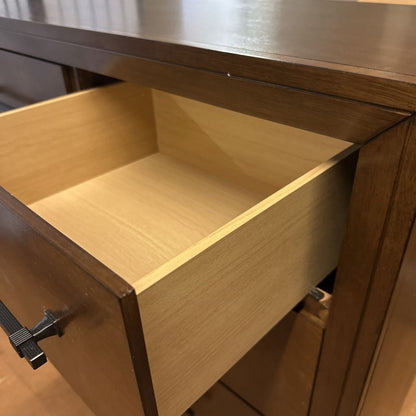 Wooden drawer with metal handle on a wooden cabinet