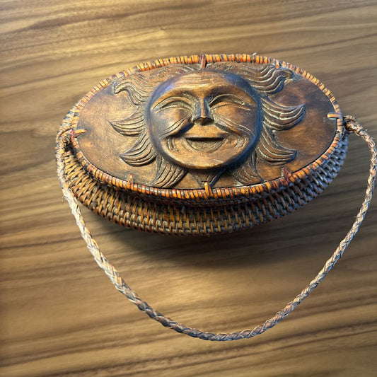 Decorative bag with sun design on a wooden surface
