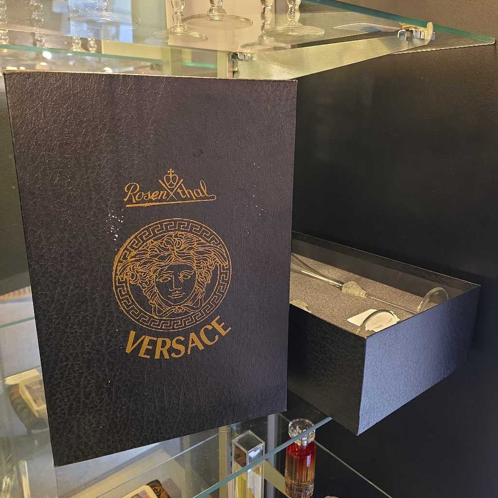 Versace packaging with Rosenfeld logo on a reflective surface
