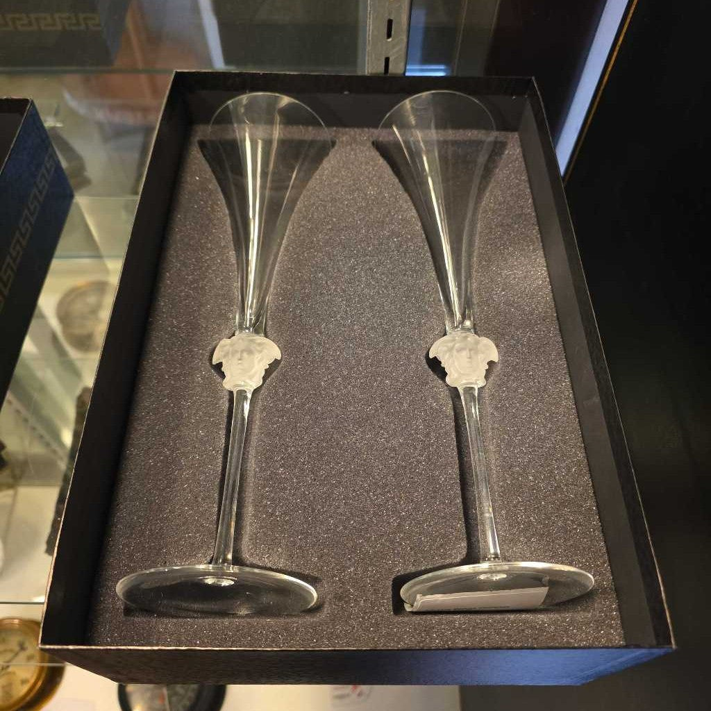 Two silver champagne flutes in a black box with a gray interior.