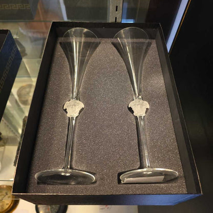 Two silver champagne flutes in a black box with a gray interior.