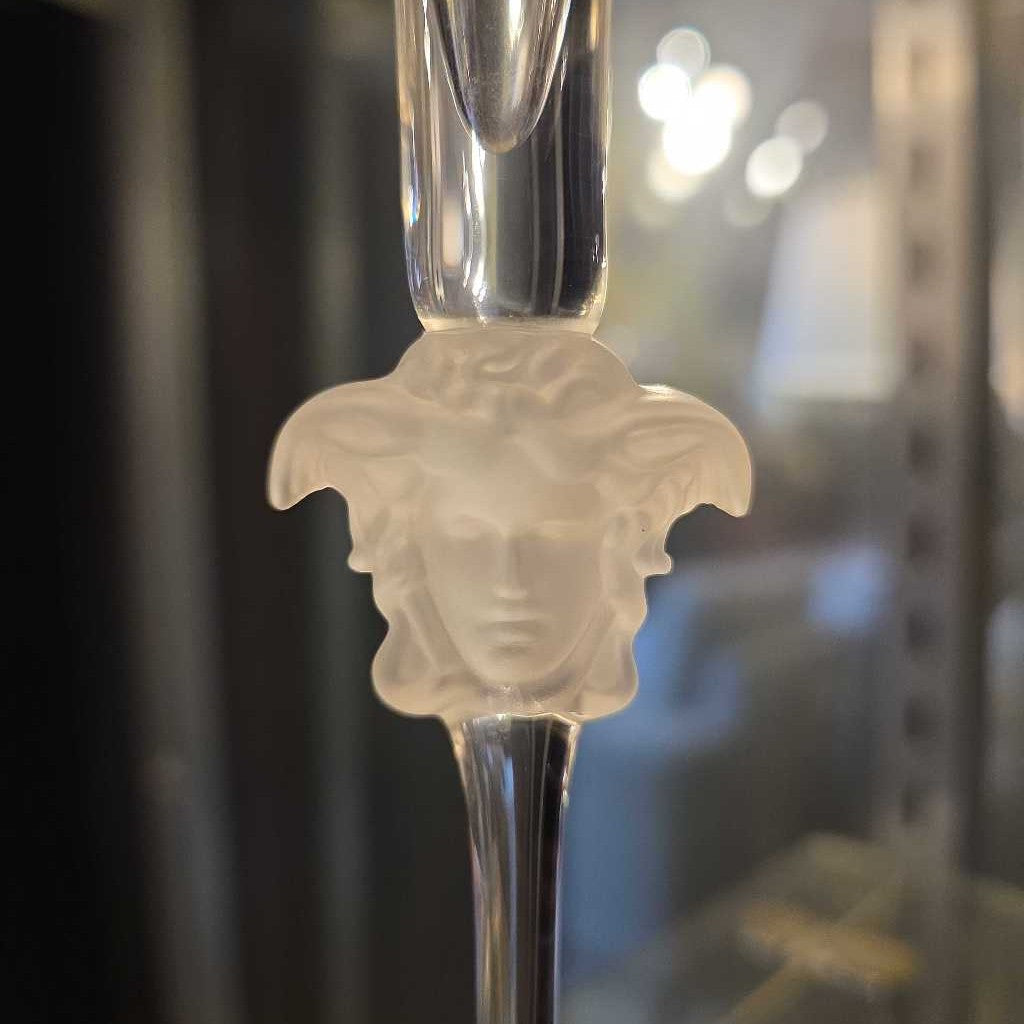 Decorative spoon with a face emblem on a blurred background