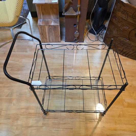 Vintage metal serving cart on a wooden floor