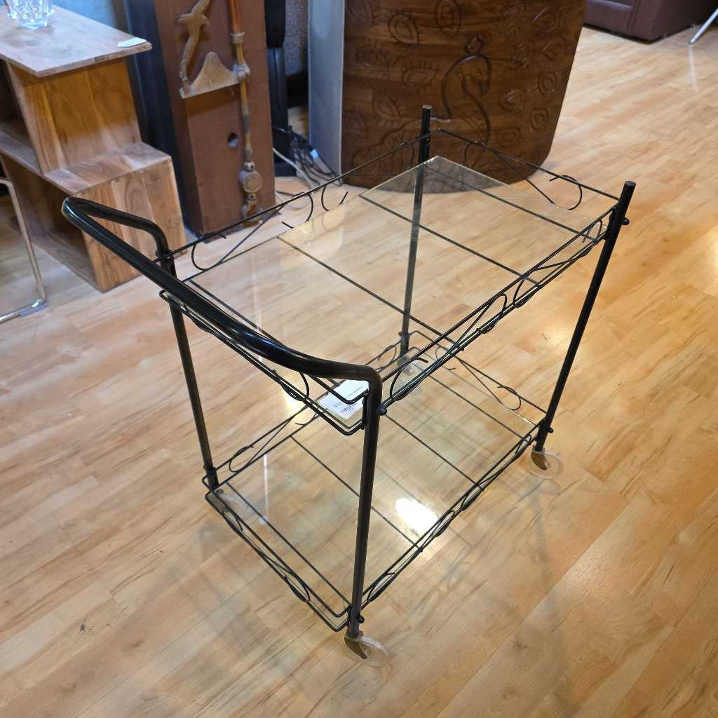 Vintage-style metal and glass serving cart on a wooden floor
