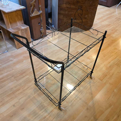 Vintage-style metal and glass serving cart on a wooden floor