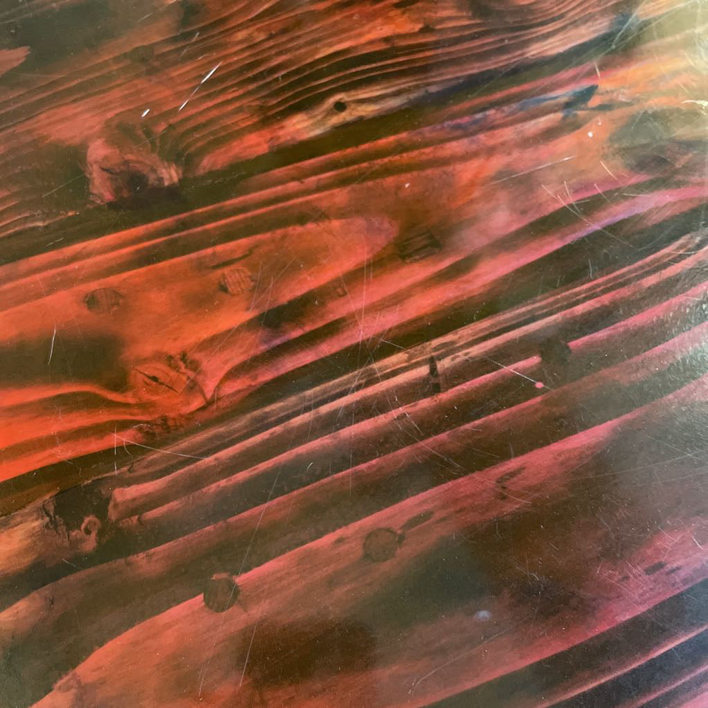 Close-up of a textured surface with red and black colors