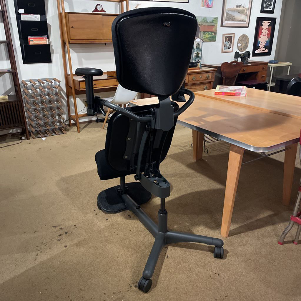 Black office chair in a room with furniture and decor