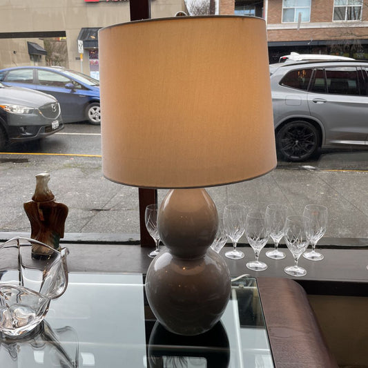 Table with lamp, glasses, and decorative items on a city street background