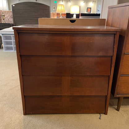 Wooden dresser with three drawers in a room setting