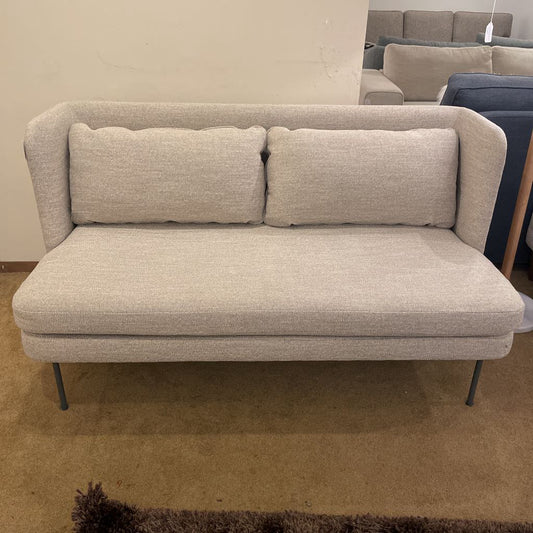 Beige sofa with cushions in a store setting