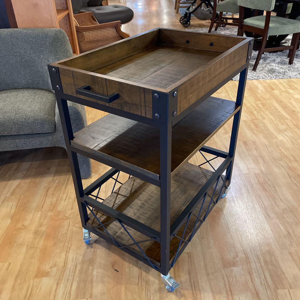 Wooden serving cart with metal frame on a wooden floor