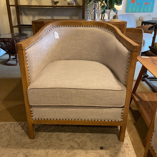 Beige armchair with wooden frame in a room setting