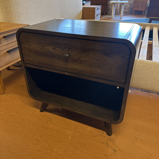 Wooden nightstand with a drawer on a wooden floor