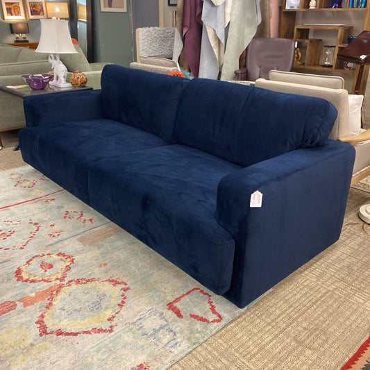 Blue sofa with a price tag in a room setting