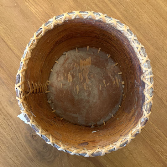 Woven wooden basket on a wooden surface