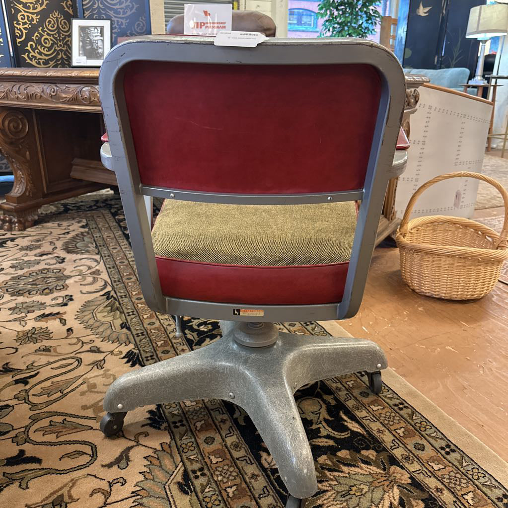 Chair with red backrest and beige seat on a patterned rug
