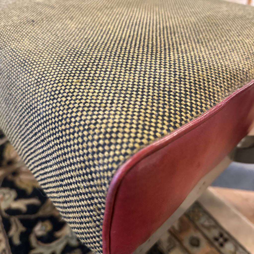 Close-up of a textured fabric surface with a red border