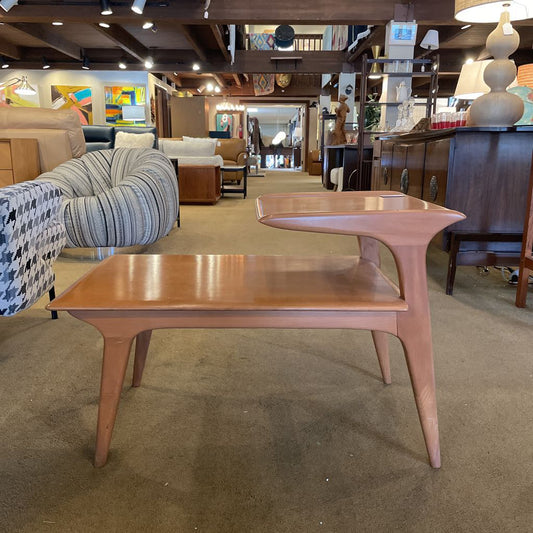 Wooden coffee table in a showroom with furniture and decor in the background