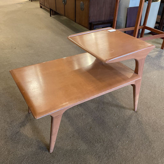 Wooden side table with a shelf on a carpeted floor