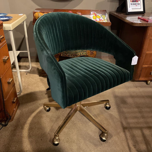 Green velvet office chair with gold base in a room setting