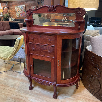 Wooden cabinet with mirror top in a living room setting
