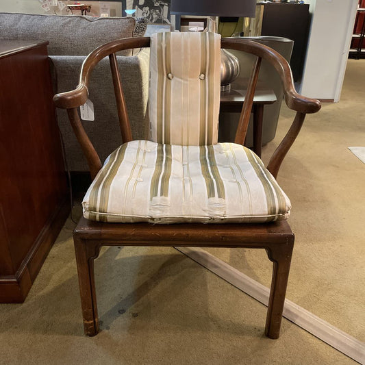 Wooden chair with striped cushion in a store setting