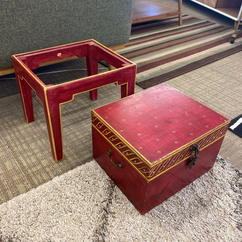 Red wooden table and box on a carpeted floor