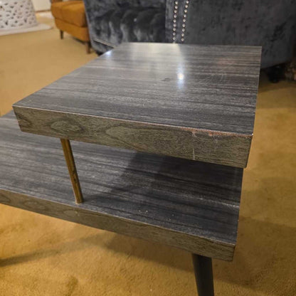 Wooden side table with a shelf in a room setting