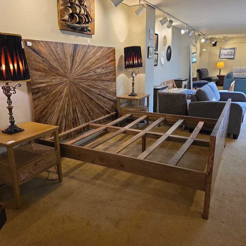 Wooden bed frame in a room with furniture and decor