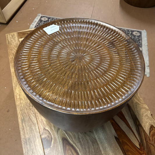 Brown textured ceramic stool on a wooden floor