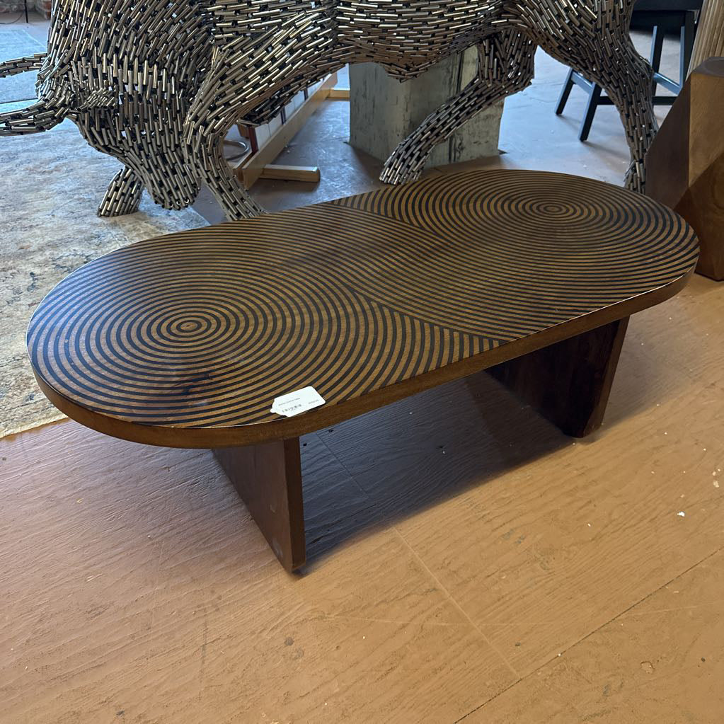 Wooden coffee table with wicker top on a wooden floor