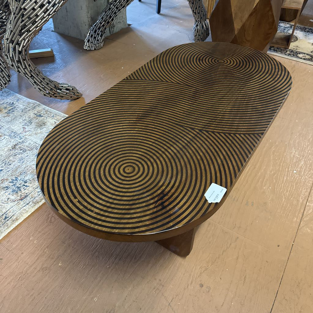 Round wooden table with spiral pattern on a wooden floor