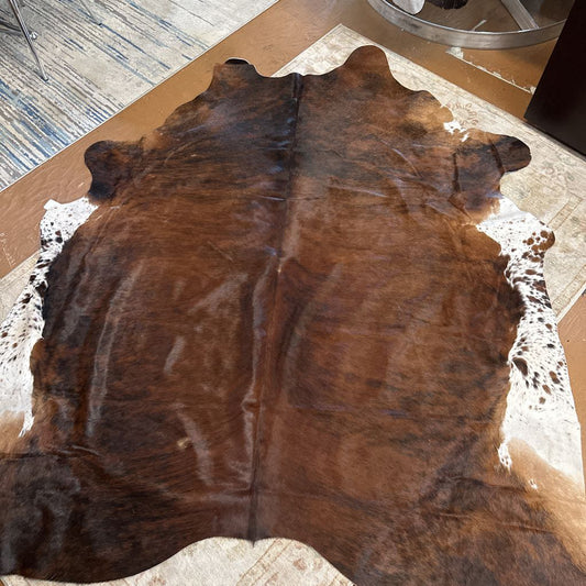 Brown cowhide rug on a wooden floor