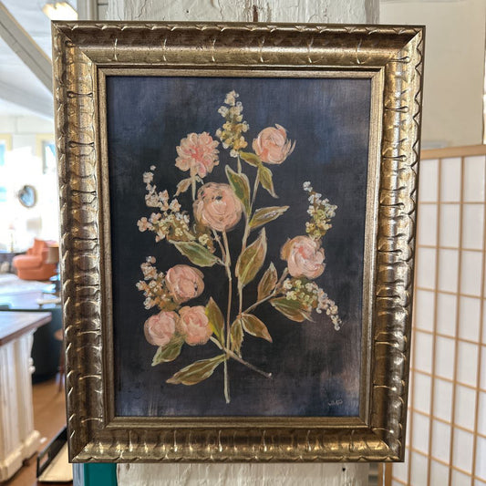 Framed floral painting with a gold frame on a dark background