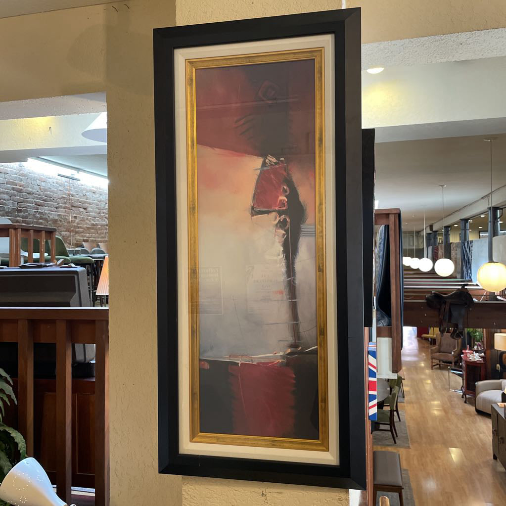 Framed abstract art piece on a wall in a modern interior setting