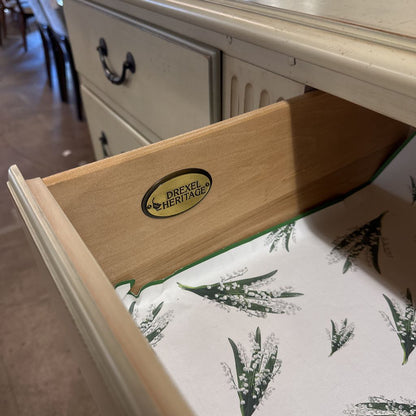 Open drawer with Drexel Heritage logo on a wooden surface