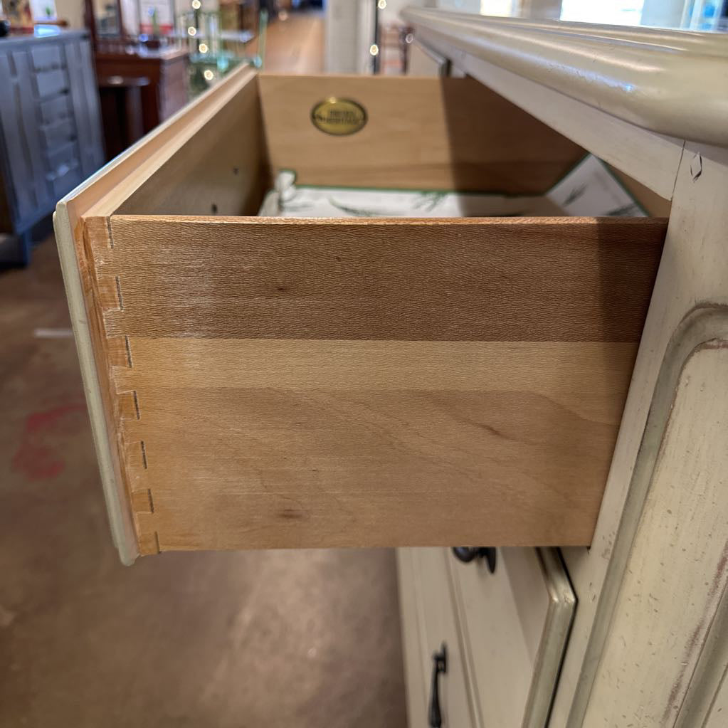 Wooden drawer being pulled out from a cabinet
