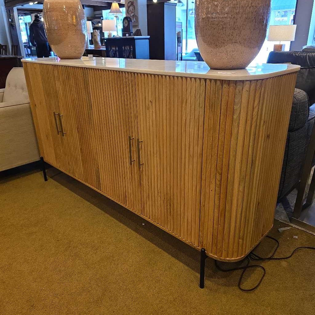 Wooden sideboard with decorative vases on a carpeted floor