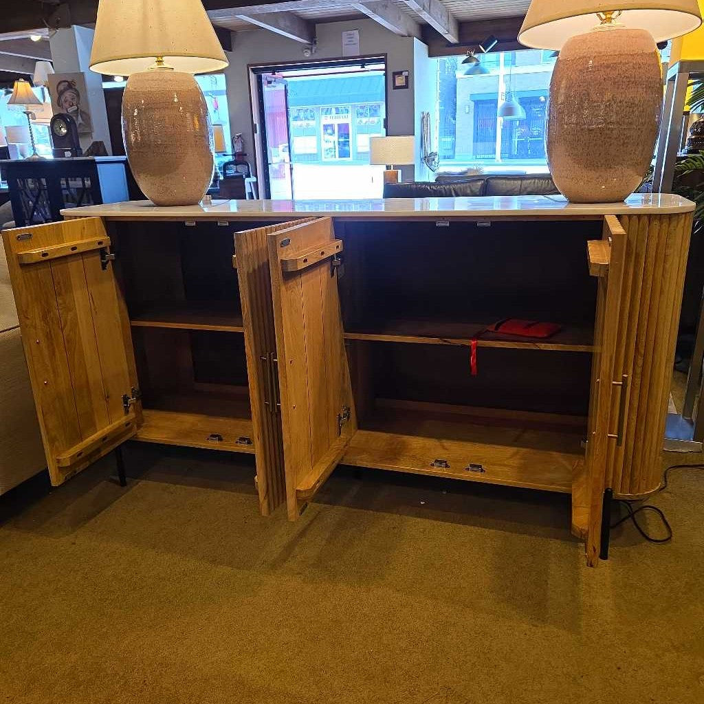 Wooden cabinet with open doors in a room with lamps and a screen.