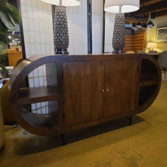 Wooden sideboard with circular design in a room setting