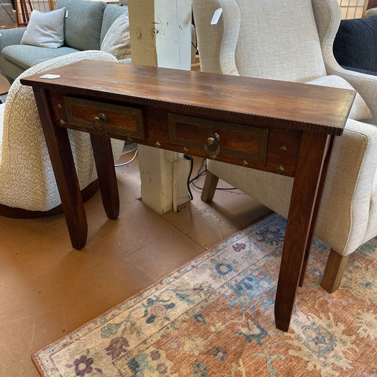 Wooden console table with drawers in a room with furniture and a rug.