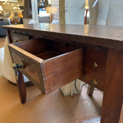 Wooden desk with an open drawer in a room setting