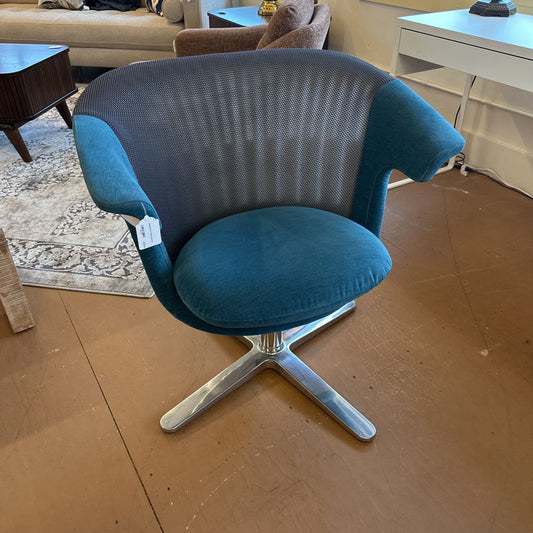 Blue swivel chair with a metal base in a room setting