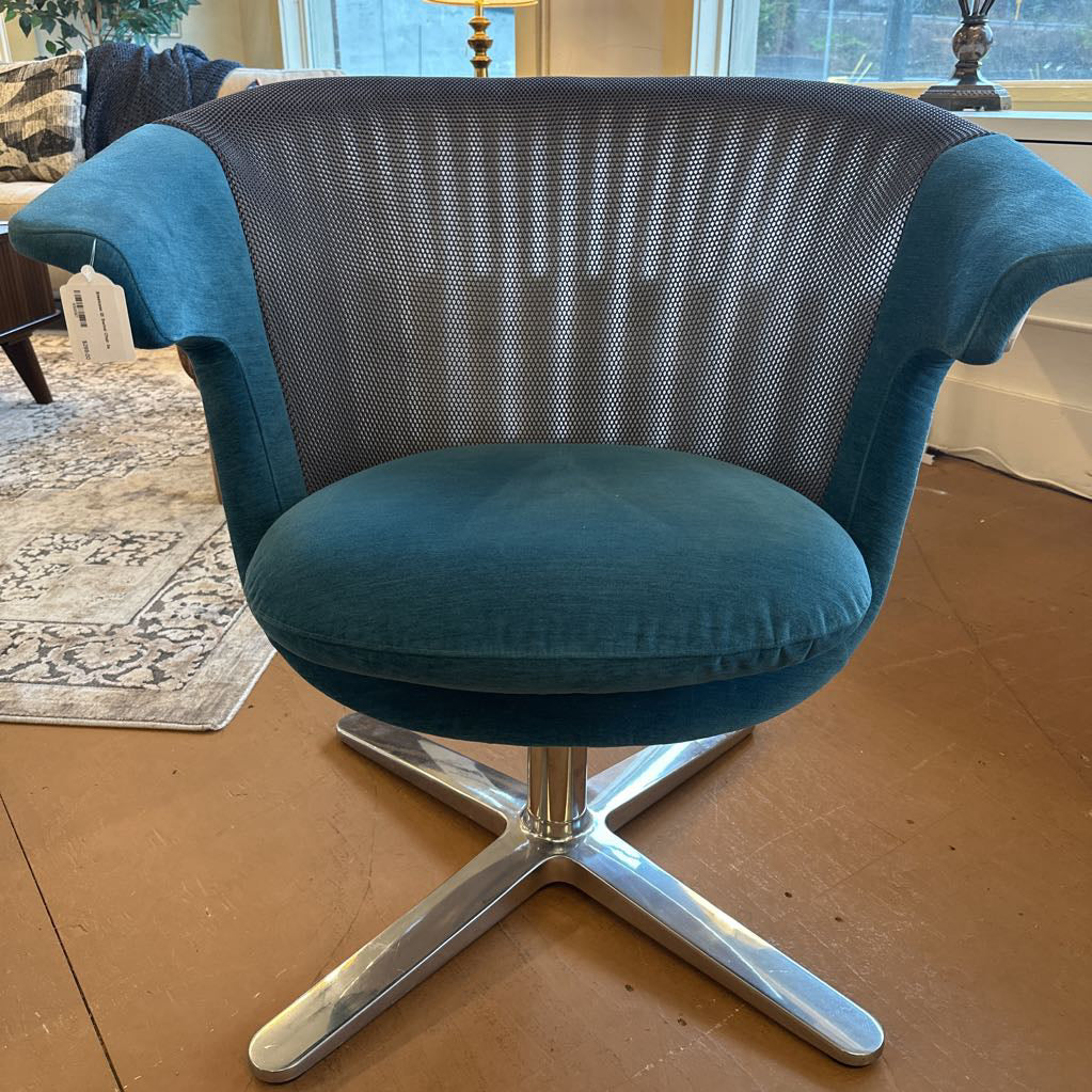 Blue swivel chair with mesh backrest in a room setting